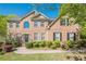 Charming brick home featuring a manicured front yard, mature landscaping, and inviting entrance at 1010 Forest Creek Dr, Canton, GA 30115