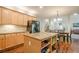 Modern kitchen with island, granite countertops, stainless steel appliances, and an adjacent dining area at 1010 Forest Creek Dr, Canton, GA 30115