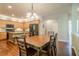 Open kitchen featuring wooden cabinets, granite countertops and an island with seating area next to the dining table at 1010 Forest Creek Dr, Canton, GA 30115