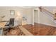 Bright office space featuring hardwood floors, a decorative rug, and a view of the staircase at 1010 Forest Creek Dr, Canton, GA 30115