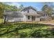 Large backyard featuring mature trees, a deck, a garage, and rear entrance to the home at 2914 Stanton Se Rd, Conyers, GA 30094