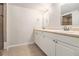Bright bathroom featuring double sinks, large mirror, and tiled floors and shower at 2914 Stanton Se Rd, Conyers, GA 30094