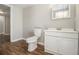 Bathroom featuring a toilet, white vanity and cabinet on a hardwood floor at 2914 Stanton Se Rd, Conyers, GA 30094