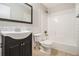Classic bathroom with a black vanity, white subway tile, and a shower-tub combo at 2914 Stanton Se Rd, Conyers, GA 30094