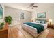 Inviting bedroom with plush bed, hardwood floors, a ceiling fan and natural light at 2914 Stanton Se Rd, Conyers, GA 30094