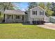 Traditional home featuring a covered front porch, manicured lawn and attached three car garage at 2914 Stanton Se Rd, Conyers, GA 30094