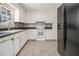 The kitchen features white cabinets, black counters, and a modern backsplash at 2914 Stanton Se Rd, Conyers, GA 30094