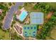 Aerial view of the community pool and tennis courts, surrounded by lush greenery and parking at 3448 Clear Stream Ne Run, Auburn, GA 30011