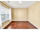 Bright bedroom with hardwood floors, neutral paint, large windows, and decorative curtains at 3448 Clear Stream Ne Run, Auburn, GA 30011