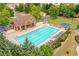 Aerial shot of a community pool surrounded by seating, offering a resort-style amenity for residents at 3448 Clear Stream Ne Run, Auburn, GA 30011