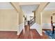 Open-concept home interior featuring hardwood floors, wainscoting, and views of the kitchen and staircase at 3448 Clear Stream Ne Run, Auburn, GA 30011
