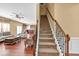 Bright foyer with hardwood floors transitioning to carpeted stairs and views of the living room at 3448 Clear Stream Ne Run, Auburn, GA 30011