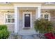 Inviting front porch with columns, stylish lighting, brick exterior, and well-maintained landscaping at 3448 Clear Stream Ne Run, Auburn, GA 30011
