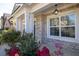 Close-up of front porch with decorative pillars, hanging lantern, brick facade, and lush landscaping at 3448 Clear Stream Ne Run, Auburn, GA 30011