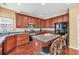 Functional kitchen featuring an island with seating, stainless steel appliances, and wood cabinets at 3448 Clear Stream Ne Run, Auburn, GA 30011