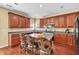 Well-equipped kitchen featuring wooden cabinets, an island with seating, and stainless steel appliances at 3448 Clear Stream Ne Run, Auburn, GA 30011
