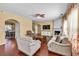 Inviting living room with hardwood floors, a fireplace, natural light, and comfortable seating at 3448 Clear Stream Ne Run, Auburn, GA 30011