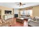 Warm living room with hardwood floors, a fireplace, neutral furniture, and natural light from windows at 3448 Clear Stream Ne Run, Auburn, GA 30011