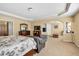 Large main bedroom showcasing a sitting area, television, and decorative columns at 3448 Clear Stream Ne Run, Auburn, GA 30011