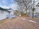 Large backyard with trees and a small deck offers plenty of space for outdoor activities and gardening at 2637 Sol Ct, Ellenwood, GA 30294