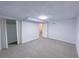 Unfinished basement offers space for storage or customization, features neutral carpet and white walls at 2637 Sol Ct, Ellenwood, GA 30294