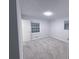 Bedroom featuring gray carpet and a window bringing in natural light at 2637 Sol Ct, Ellenwood, GA 30294