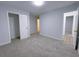 Bedroom featuring gray carpet and two closets with doors open at 2637 Sol Ct, Ellenwood, GA 30294