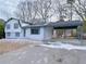 Side view of a charming two-story home featuring a covered carport and well-maintained driveway at 2637 Sol Ct, Ellenwood, GA 30294