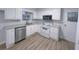 Kitchen with stainless appliances, white cabinets and stylish gray countertops at 2637 Sol Ct, Ellenwood, GA 30294
