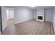 Spacious living room featuring hardwood floors, a fireplace, and neutral paint for versatile decor at 2637 Sol Ct, Ellenwood, GA 30294