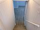 Carpeted stairs leading down to a room with vinyl flooring at 2637 Sol Ct, Ellenwood, GA 30294
