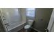 Full bathroom featuring a white tub and wood-look flooring at 2917 Joe Jerkins Blvd, Austell, GA 30106