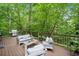 Relaxing back deck with outdoor seating, a grill, and a lush green backdrop at 5276 Weatherwood Trce, Marietta, GA 30068