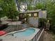 Backyard oasis featuring a sparkling pool, relaxing hot tub, stone wall, and multi-tiered deck at 5276 Weatherwood Trce, Marietta, GA 30068