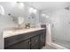 Modern bathroom features double sinks, sleek vanity and tiled walk-in shower at 5276 Weatherwood Trce, Marietta, GA 30068