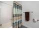 Clean, bright bathroom featuring neutral shower curtain and gray tile floors at 5276 Weatherwood Trce, Marietta, GA 30068