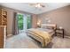 Cozy bedroom featuring neutral walls, plush carpet and a sliding door to outdoor at 5276 Weatherwood Trce, Marietta, GA 30068