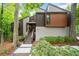 Striking modern home featuring wood and gray siding, landscaped front yard and elevated entryway with stairs at 5276 Weatherwood Trce, Marietta, GA 30068