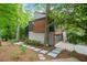 Contemporary home showcasing a stylish facade with clean lines, landscaped front yard, and a driveway at 5276 Weatherwood Trce, Marietta, GA 30068
