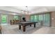 Spacious game room with a pool table and sliding glass doors to the outside at 5276 Weatherwood Trce, Marietta, GA 30068