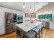 Modern kitchen boasts stainless steel appliances, sleek cabinetry, an island with seating, and hardwood floors at 5276 Weatherwood Trce, Marietta, GA 30068