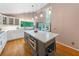 Spacious kitchen with hardwood floors, stone countertops, stainless appliances, and a view of the backyard at 5276 Weatherwood Trce, Marietta, GA 30068