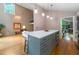 Open concept kitchen with eat in island, stainless appliances, and hardwood floors next to an open living space at 5276 Weatherwood Trce, Marietta, GA 30068