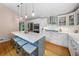 Bright kitchen boasts stainless steel appliances, white cabinets, an island with seating, and hardwood floors at 5276 Weatherwood Trce, Marietta, GA 30068