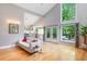 Living room with large windows, an open layout, hardwood floors, and access to the backyard deck at 5276 Weatherwood Trce, Marietta, GA 30068