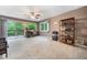 Living room with hardwood floors, ceiling fan, and sliding glass doors to deck at 5276 Weatherwood Trce, Marietta, GA 30068