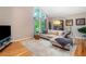 Comfortable living room features hardwood floors, large windows, and a plush sectional sofa at 5276 Weatherwood Trce, Marietta, GA 30068