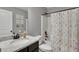 Bathroom featuring a granite-topped vanity, toilet and tiled tub-shower with fun curtain at 542 Broughton Dr, Canton, GA 30114