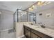Bright bathroom with a granite double vanity and glass enclosed tiled shower at 542 Broughton Dr, Canton, GA 30114