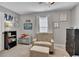 Bedroom featuring neutral tones, plush armchair and natural light from a window at 542 Broughton Dr, Canton, GA 30114